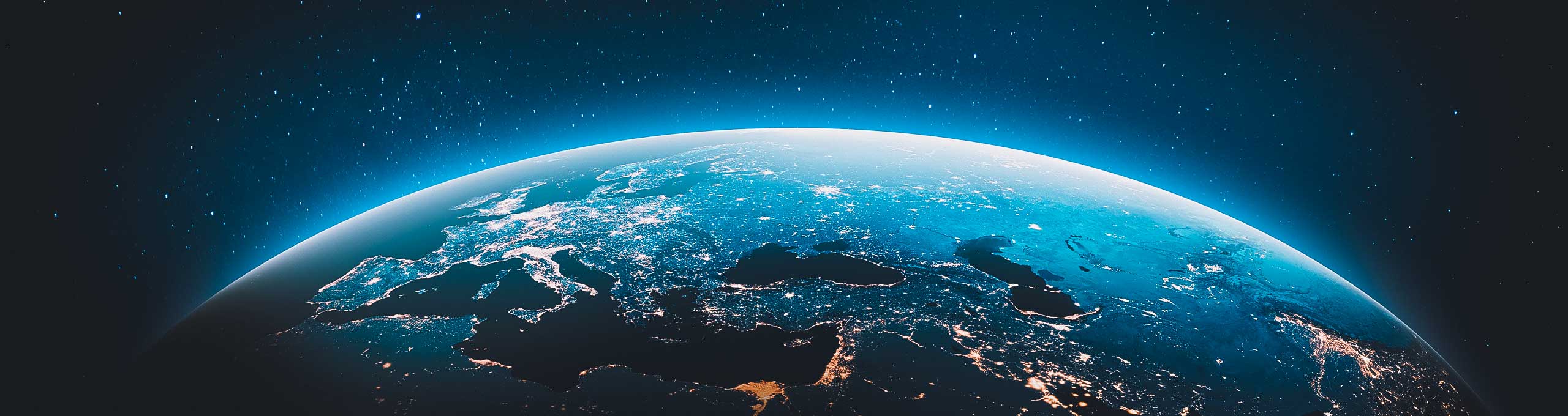A close-up of a hand holding processed basmati rice grains during a detailed quality inspection process at a rice mill.